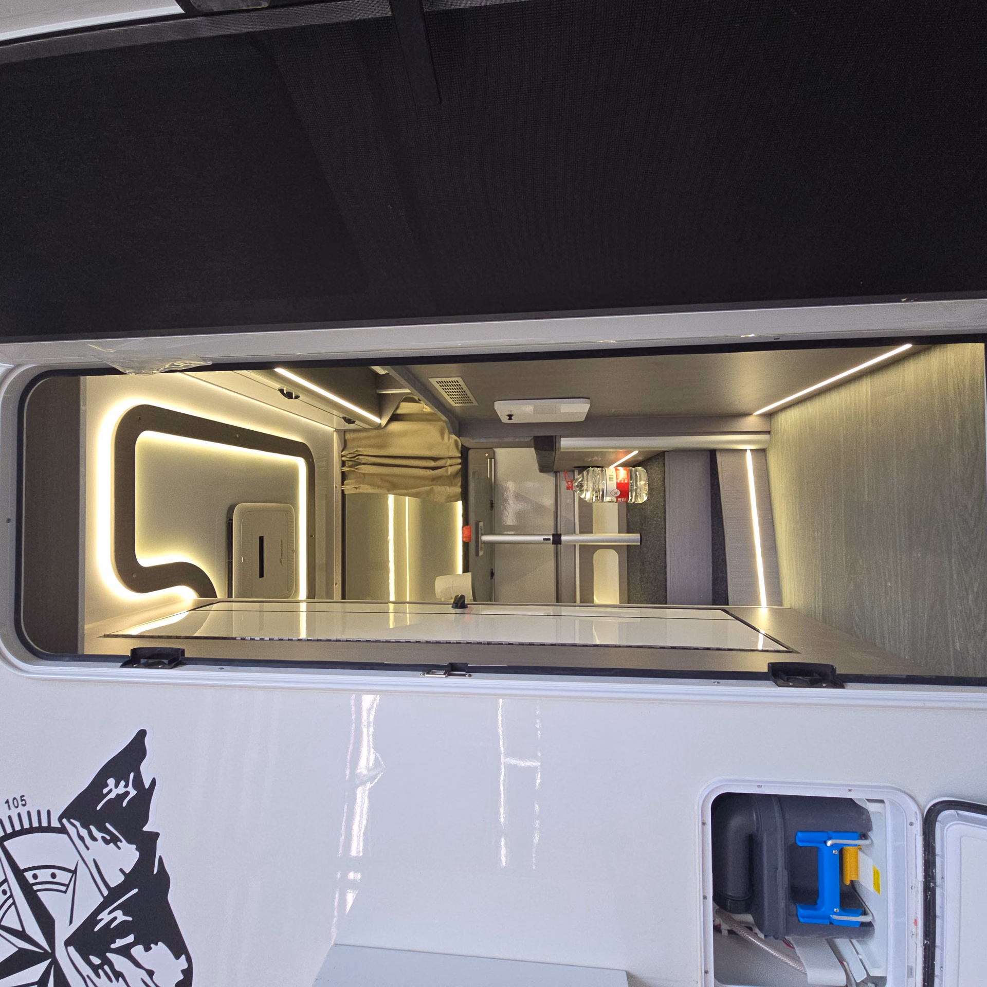 Illuminated entrance and interior of a Kalowen truck camper